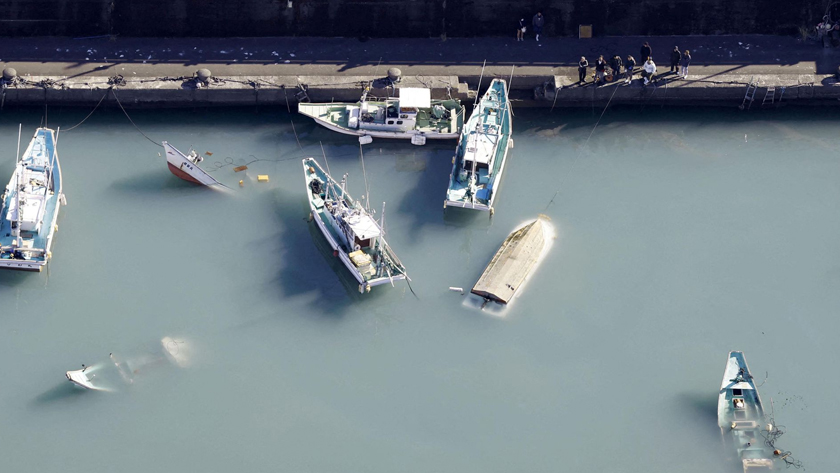 An aerial view shows capsized boats believed to be affected by the tsunami caused by an underwater volcano eruption on the island of Tonga at the South Pacific, in Muroto, Kochi prefecture, Japan, in this photo taken by Kyodo January 16, 2022. Mandatory credit Kyodo/via REUTERS