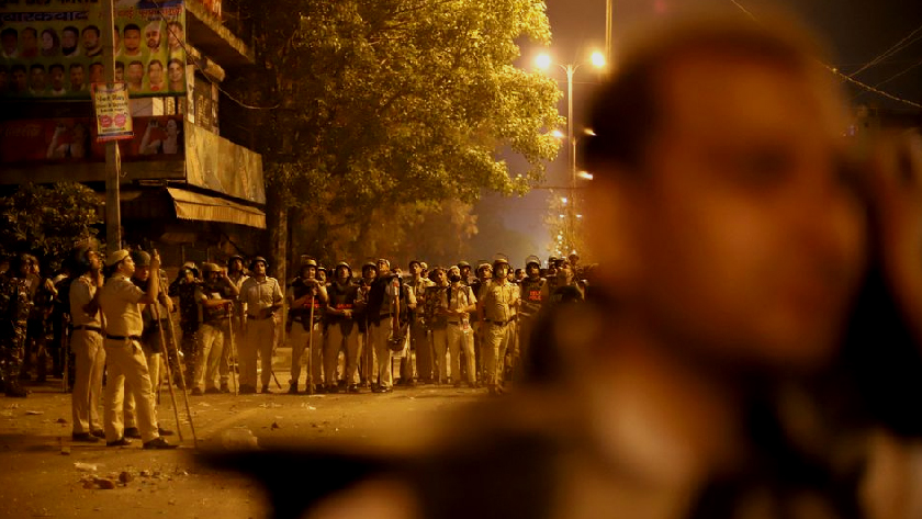 Police personnel stand guard after clashes broke out during a Hindu religious procession in Jahangirpuri area of New Delhi, India, April 16, 2022. REUTERS/Stringer