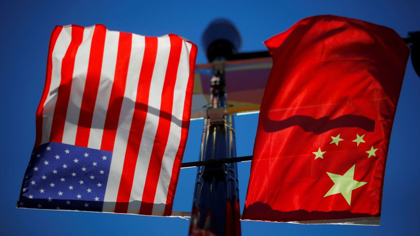 The flags of the United States and China fly from a lamppost in the Chinatown neighborhood of Boston, Massachusetts, U.S., November 1, 2021. REUTERS/Brian Snyder