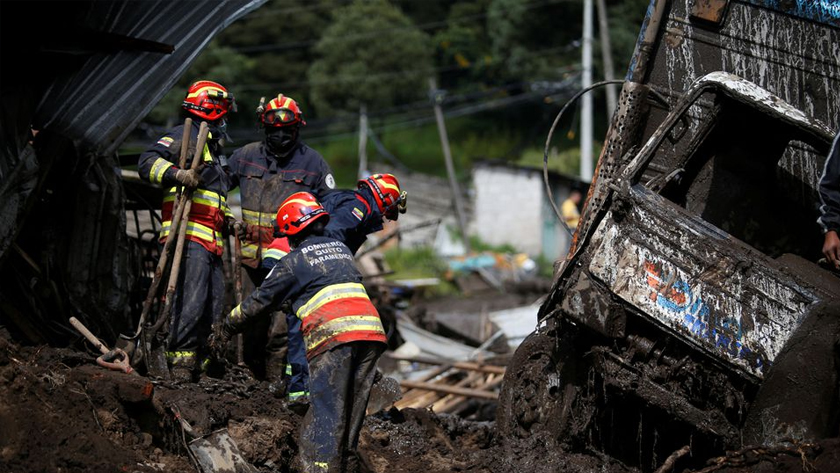 Firefighter rescue crews are seen as they continue searching homes and streets covered by mud in Quito, Ecuador, February 1, 2022. REUTERS/Jonatan Rosas