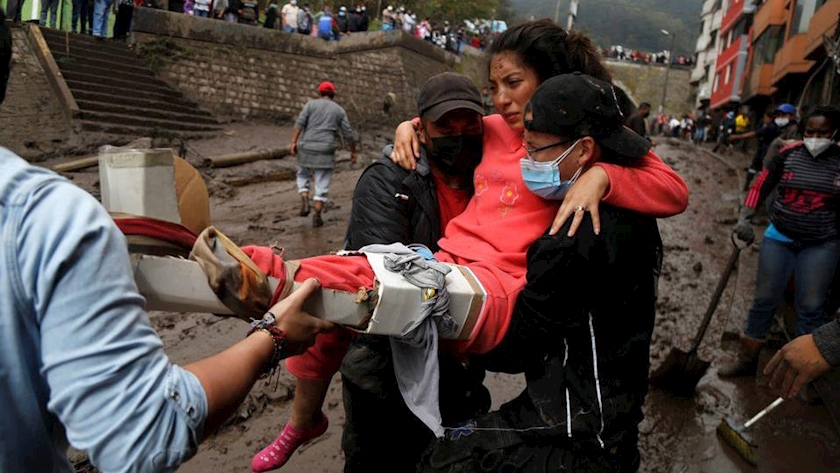 Karen Maite, 16, is helped by rescue crews in an area of a landslide in Quito, Ecuador, February 1, 2022. REUTERS/Jonatan Rosas