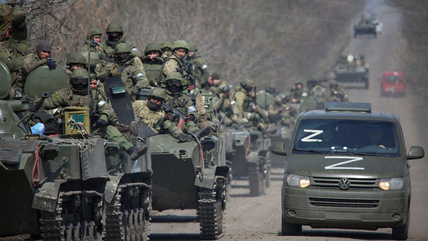 Service members of pro-Russian troops ride on armoured vehicles in the course of Ukraine-Russia conflict on a road leading to the city of Mariupol, Ukraine April 15, 2022. REUTERS/Chingis Kondarov