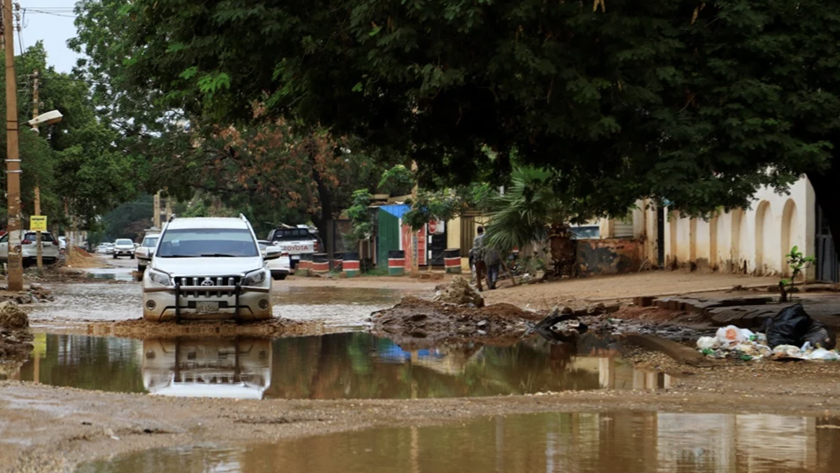 Cars drive in flood water following heavy rain in Sudan’s capital Khartoum, on August 13, 2022. ASHRAF SHAZLY / AFP