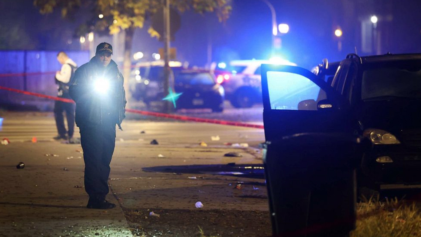 Police investigate the scene where as many as 14 people were shot on Oct. 31, 2022 in Chicago, Illinois. Scott Olson/Getty Images