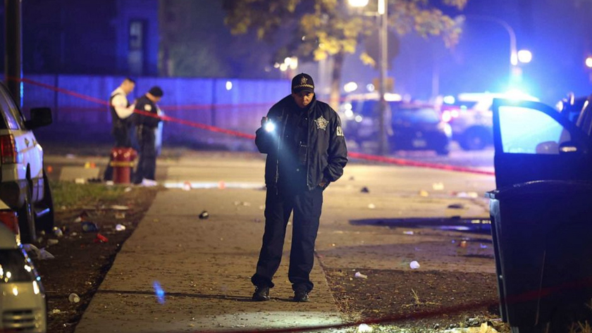 Police investigate the scene where as many as 14 people were said to have been shot on Oct. 31, 2022, in Chicago, Illinois. Scott Olson/Getty Images