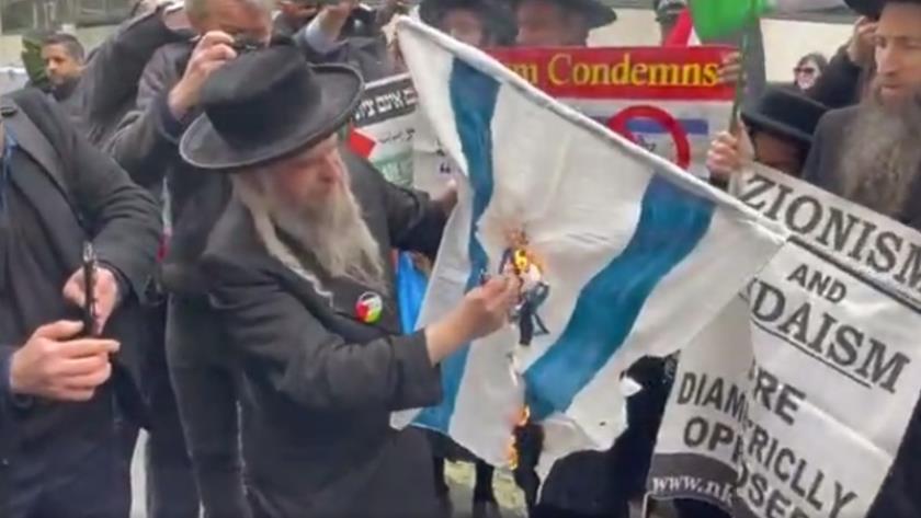 Iranpress: Demonstrators set fire to Israeli flag in London