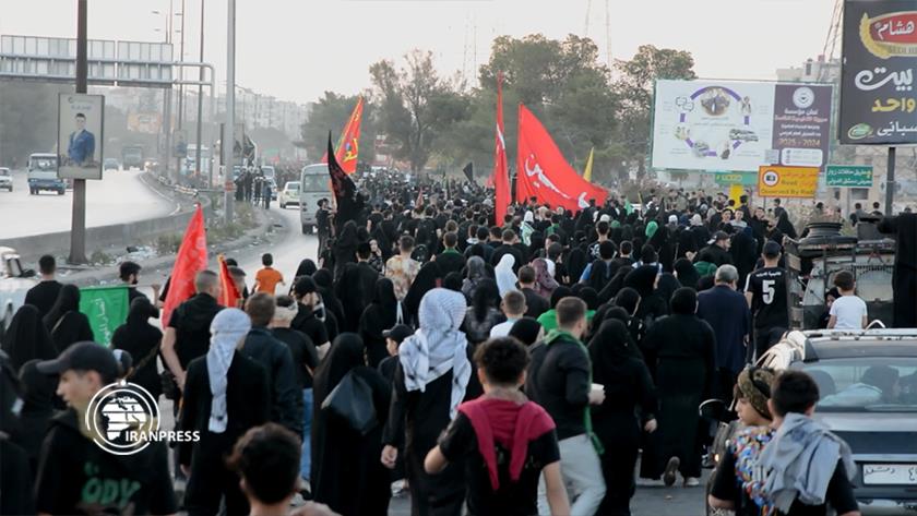 Iranpress: Thousands of Muslims March in Damascus for Arbaeen Procession 