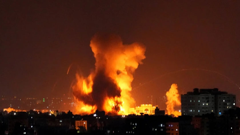 ​​​​Smoke rises following Israeli air raids on a building in Gaza City on Friday [Hatem Moussa/AP]